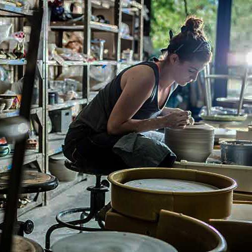 student molding clay in the cfpa ceramics studio